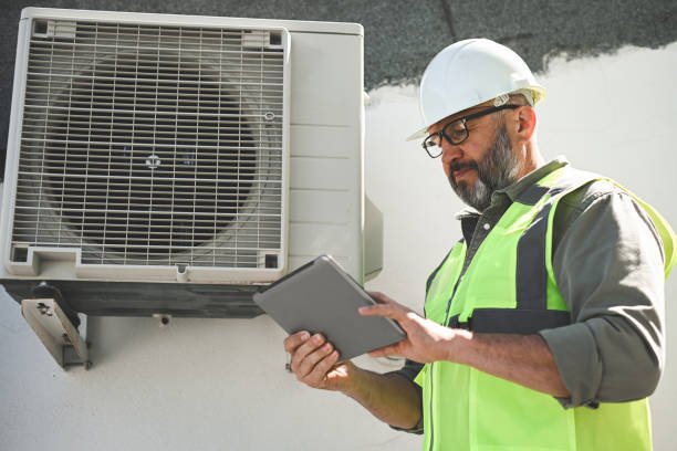 Engineer repairs air conditioner, focusing on professional AC system maintenance in Weston FL.