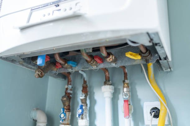 Water leaking from a broken natural gas combi boiler, highlighting the importance of thermostat repair services in Coral Springs to maintain HVAC systems.